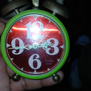 vintage Florn alarm clock, likely made in West Germany, with a bright red and gr